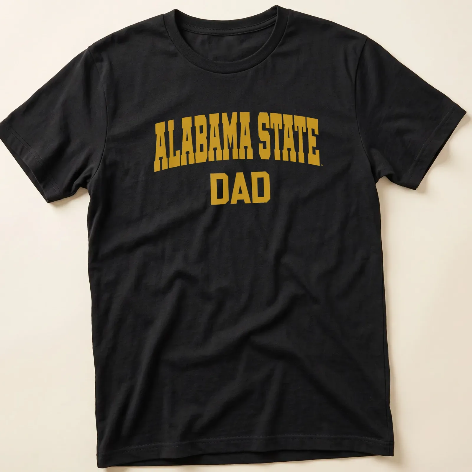 Bold collegiate Alabama State Dad T-shirt in gold lettering — printed on a unisex t-shirt