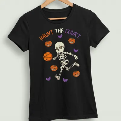 Playful skeleton dribbling a basketball with Halloween vibes — printed on a women's shirt