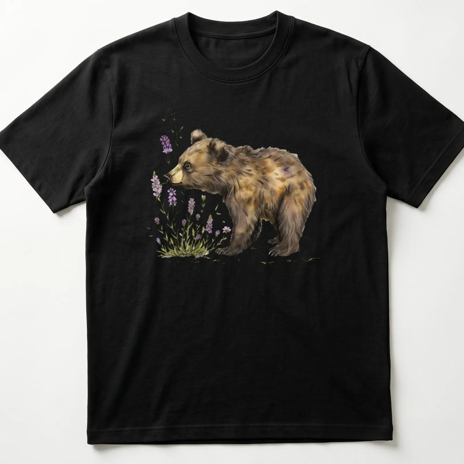 Watercolor illustration of a bear cub sniffing lavender flowers in soft colors — printed on a unisex t-shirt