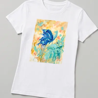 Abstract watercolor design of a Blue Morpho Butterfly in vibrant colors — printed on a women's shirt