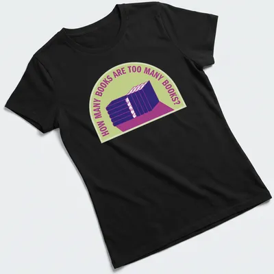 Bold typography t-shirt with humorous text about book collecting over a stack of books — printed on a women's shirt