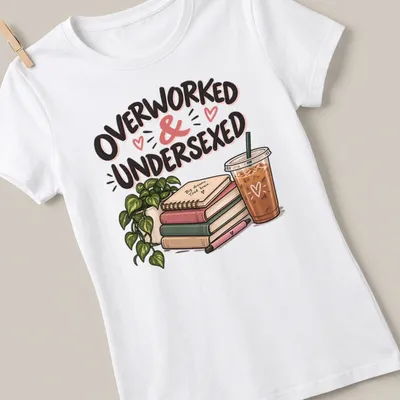 Illustrative design featuring books and coffee with the phrase 'Overworked & Undersexed' in fun typography — printed on a women's shirt