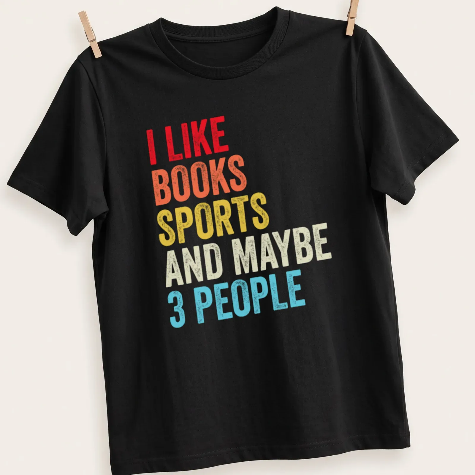 Colorful typography shirt stating I Like Books Sports And Maybe 3 People — printed on a unisex t-shirt
