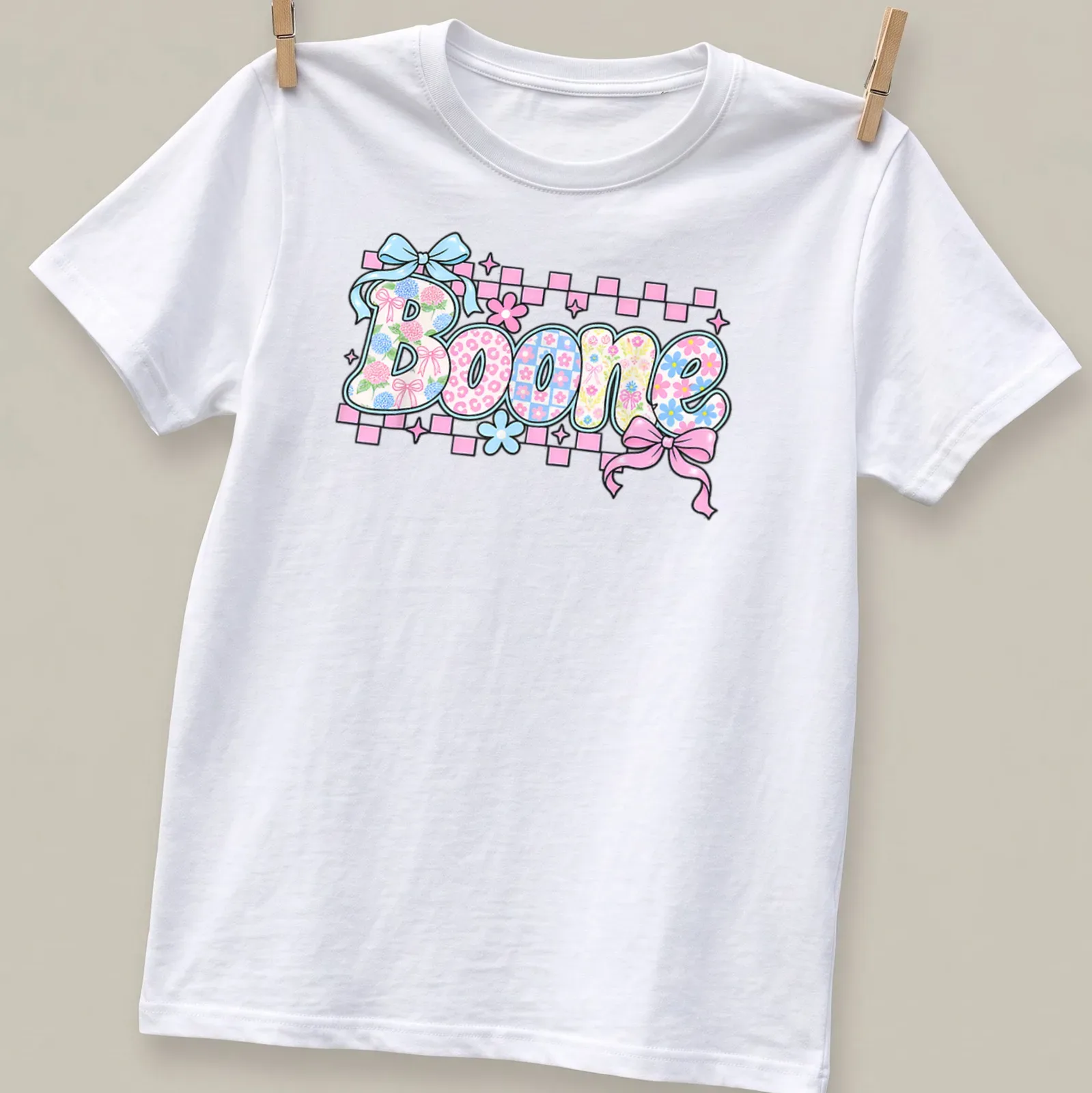 Vintage t-shirt featuring 'Boone' in floral pattern with pink, blue, green, and white colors. — printed on a unisex t-shirt