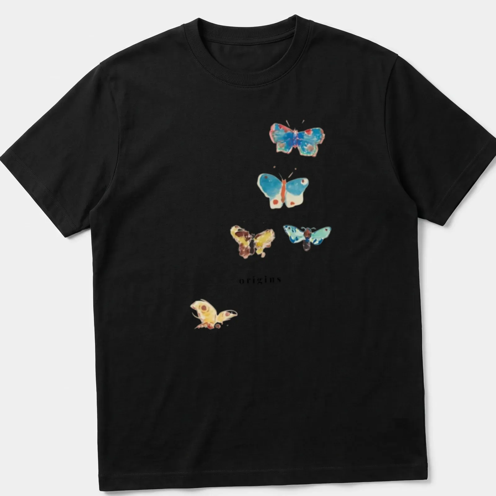 Watercolor print of colorful butterflies surrounding the word 'origins' in elegant script — printed on a unisex t-shirt