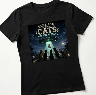 Detailed sci-fi print of cats being abducted by a UFO, with playful text. — printed on a women's shirt