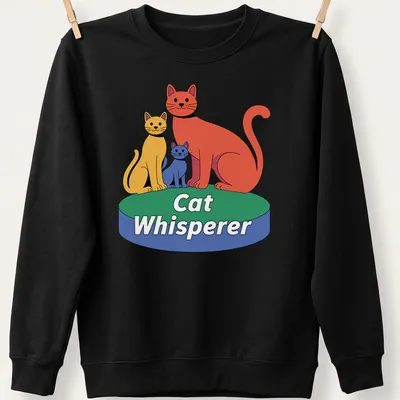 Playful cartoon design with the text 'Cat Whisperer' surrounded by sketches of cats in red, yellow, blue, and green. — printed on a unisex sweatshirt