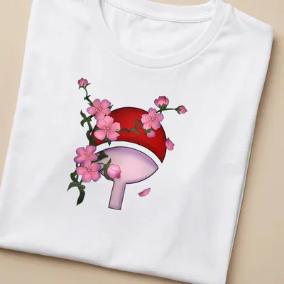 Doodle of Sharingan symbol with cherry blossoms in red, pink, and green — printed on a women's shirt