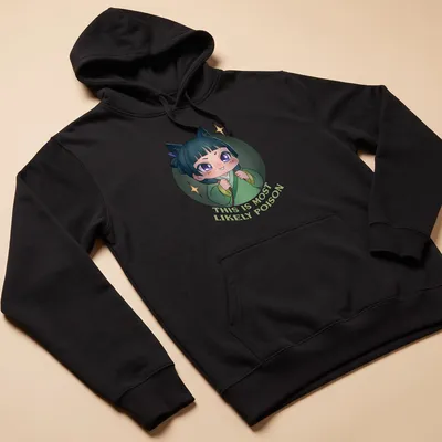 Kawaii chibi character with playful text 'THIS IS MOST LIKELY POISON' in green, blue, purple, and white — printed on a unisex hoodie