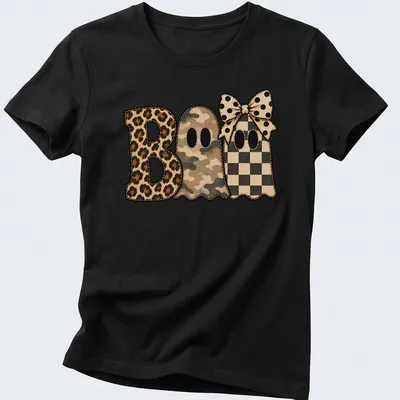 Whimsical patchwork shirt featuring cute ghosts and 'Boo' text in various patterns — printed on a women's shirt