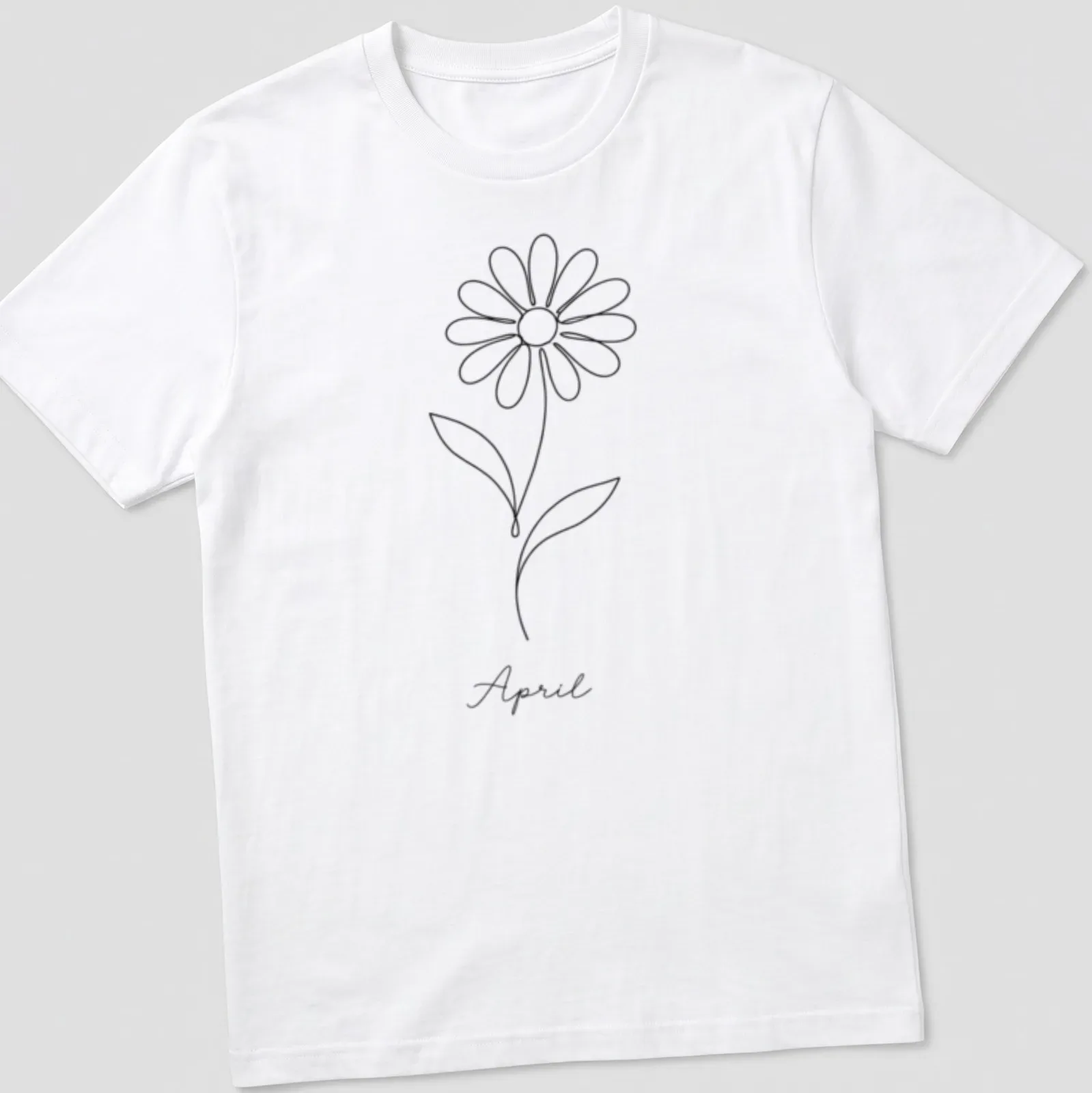 Minimalist line art of a daisy and the word April in black and white — printed on a unisex t-shirt
