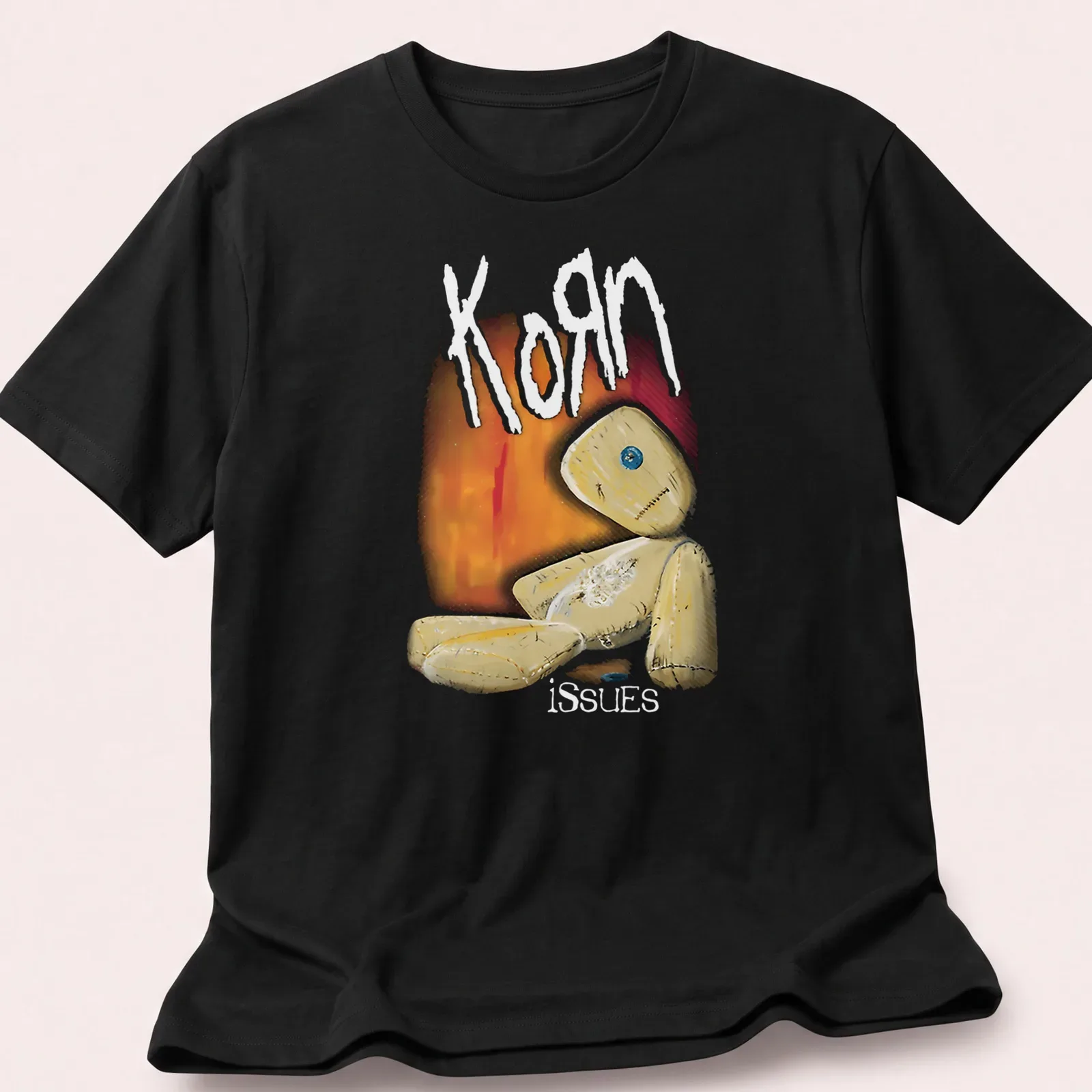 Illustrative print featuring a quirky doll and the text Korn issues in playful colors. — printed on a unisex t-shirt