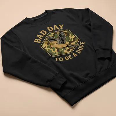 Camo print shirt featuring a dove and the text 'BAD DAY TO BE A DOVE' — printed on a unisex sweatshirt