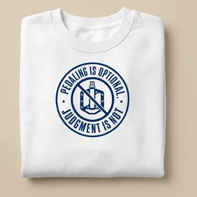 Bold typography shirt featuring the phrase 'PEDALING IS OPTIONAL, JUDGMENT IS NOT' with bike graphics — printed on a unisex sweatshirt