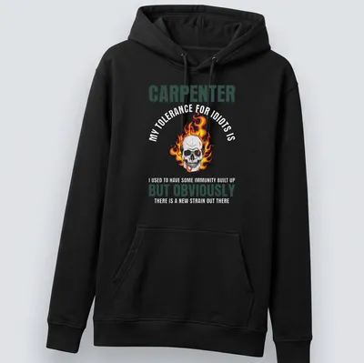 Bold graphic of a flaming skull with text 'CARPENTER BUT OBVIOUSLY' in black and orange — printed on a unisex hoodie