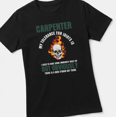 Bold graphic of a flaming skull with text 'CARPENTER BUT OBVIOUSLY' in black and orange — printed on a women's shirt