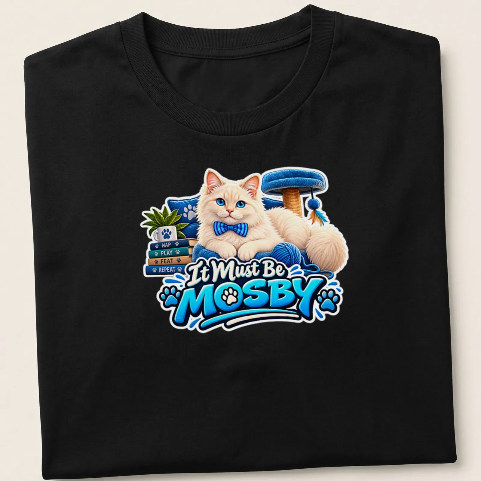 Colorful cartoon of a fluffy white cat with the text It Must Be MOSBY. — printed on a unisex t-shirt