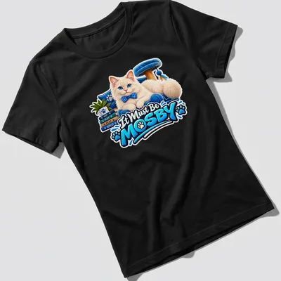 Colorful cartoon of a fluffy white cat with the text It Must Be MOSBY. — printed on a women's shirt