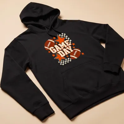 Retro distressed Game Day t-shirt featuring a football and stars in black and orange — printed on a unisex hoodie