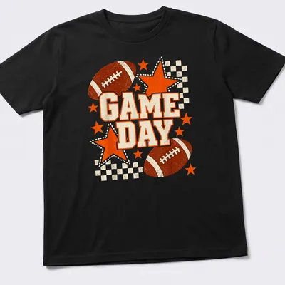 Retro distressed Game Day t-shirt featuring a football and stars in black and orange