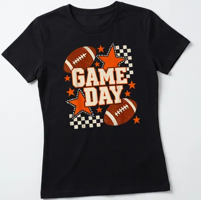 Retro distressed Game Day t-shirt featuring a football and stars in black and orange — printed on a women's shirt