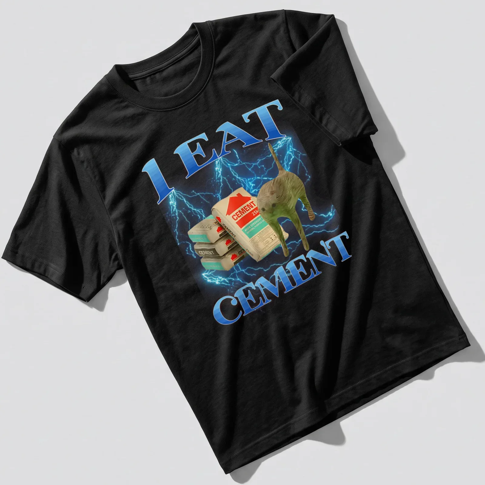 Funny cat graphic with text 'I EAT CEMENT' in blue and gray — printed on a unisex t-shirt