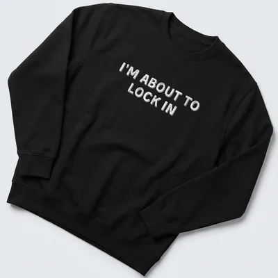 Bold white text on a humorous design stating I'm About To Lock In — printed on a unisex sweatshirt