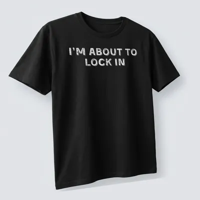Bold white text on a humorous design stating I'm About To Lock In — printed on a unisex t-shirt (angled view)