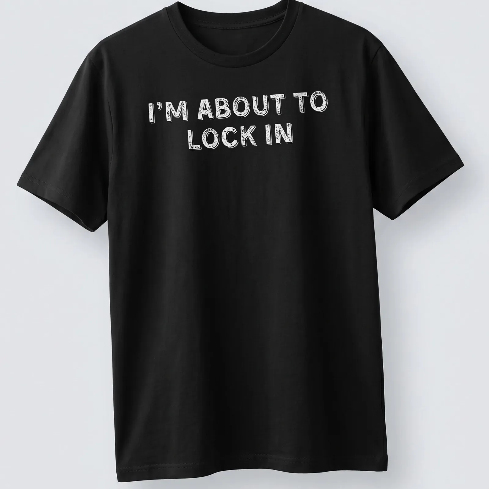 Bold white text on a humorous design stating I'm About To Lock In — printed on a unisex t-shirt