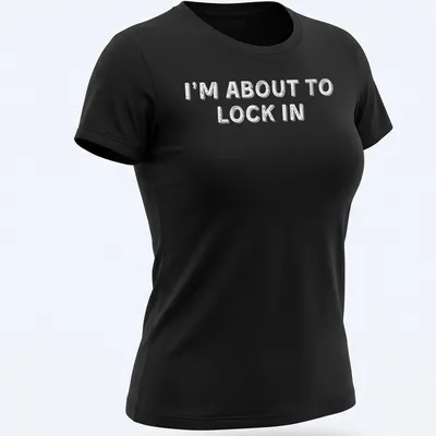 Bold white text on a humorous design stating I'm About To Lock In — printed on a women's shirt