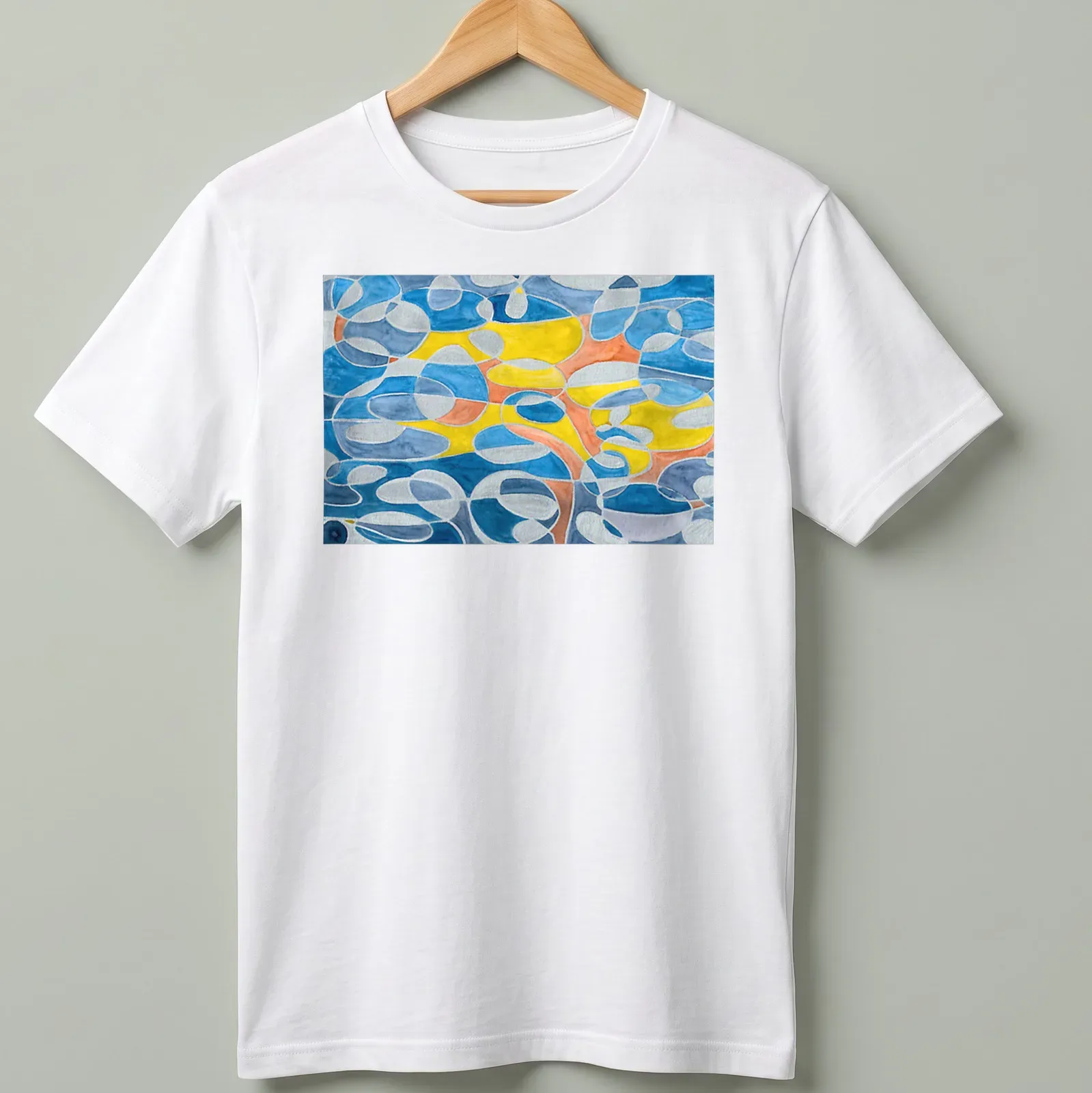 Geometric abstract design in blue, grey, mustard, orange, and white — printed on a unisex t-shirt