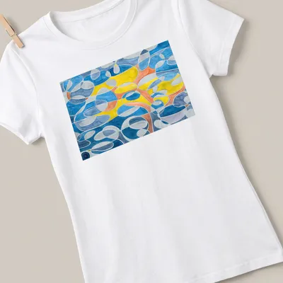 Geometric abstract design in blue, grey, mustard, orange, and white — printed on a women's shirt