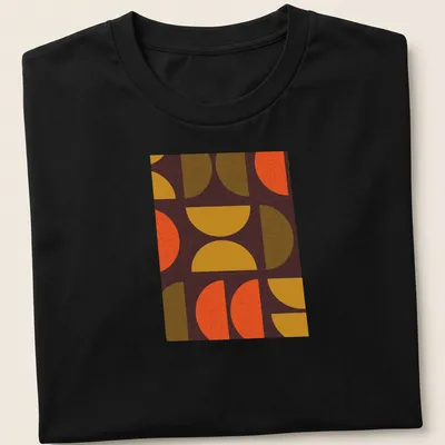 Textured geometric shapes t-shirt in warm colors of orange, yellow, brown, and green
