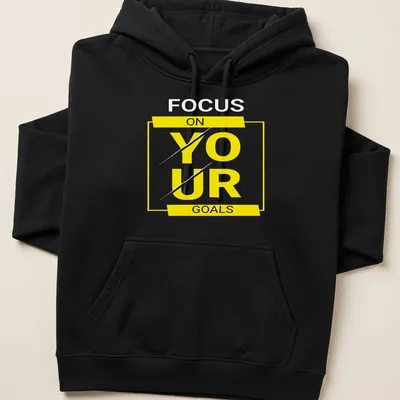 Bold typography shirt with motivational text 'FOCUS ON YOUR GOALS' in yellow, black, and white. — printed on a unisex hoodie