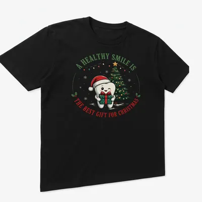 Cute cartoon tooth character with a Christmas tree and text about healthy smiles — printed on a unisex t-shirt (angled view)