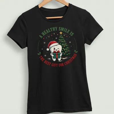 Cute cartoon tooth character with a Christmas tree and text about healthy smiles — printed on a women's shirt
