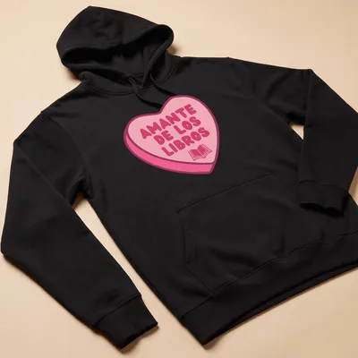 Kawaii design with a heart shape filled with books and text Amante De Los Libros — printed on a unisex hoodie