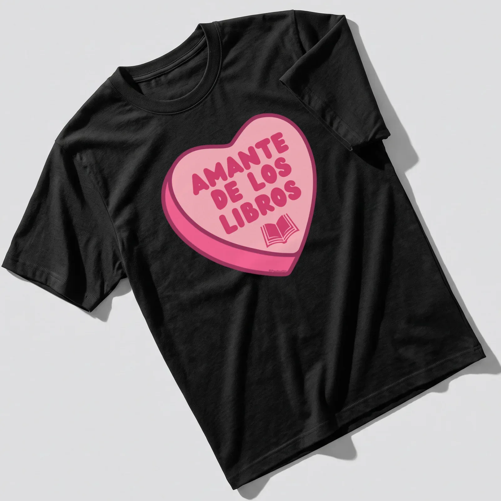 Kawaii design with a heart shape filled with books and text Amante De Los Libros — printed on a unisex t-shirt