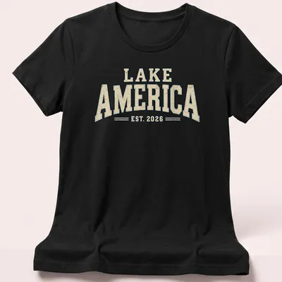 Vintage design featuring Lake America EST. 2026 text in cream, navy, and beige. — printed on a women's shirt