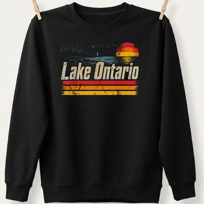 Retro distressed Lake Ontario T-shirt featuring sunset colors in orange, yellow, light blue, and white — printed on a unisex sweatshirt