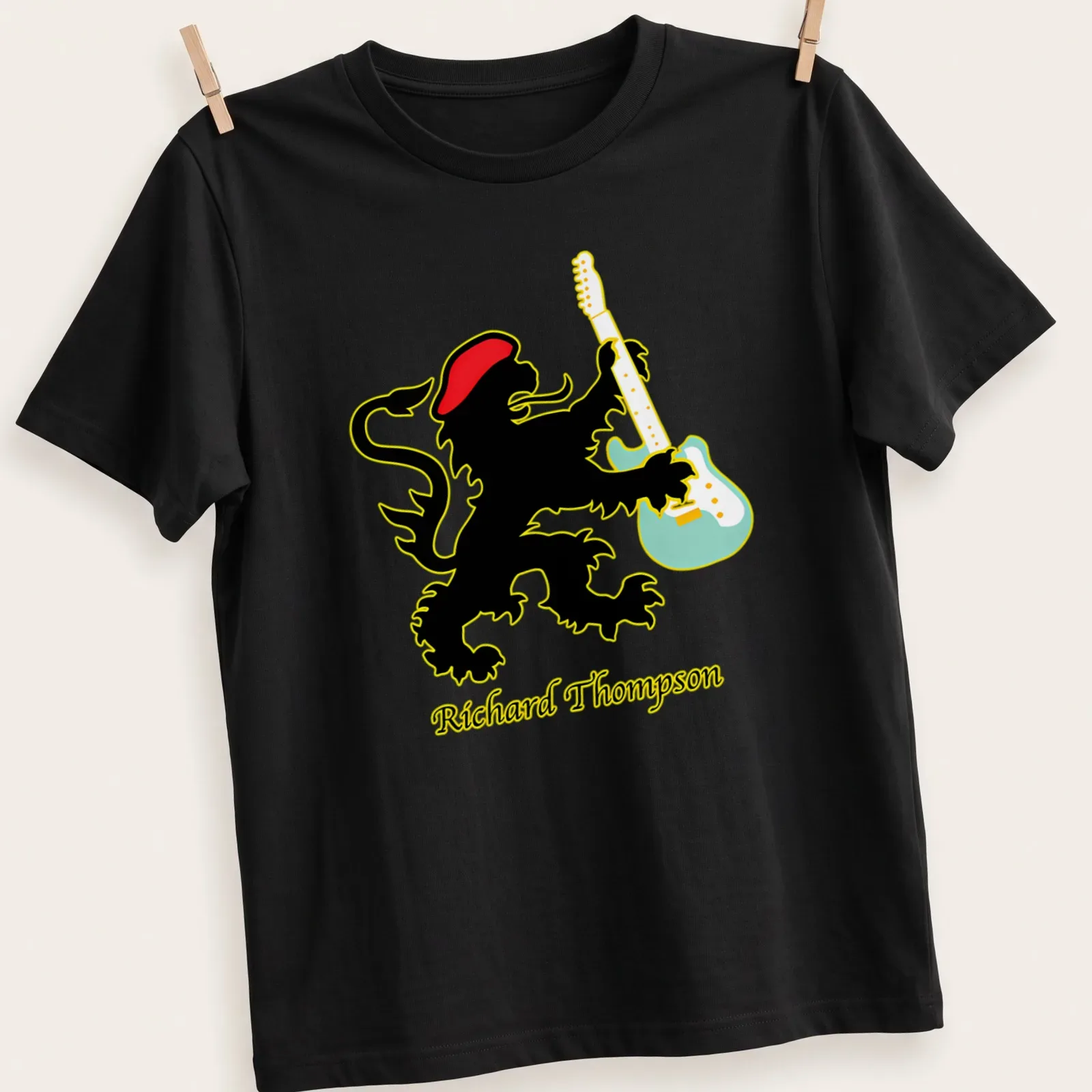 Colorful illustration of a lion playing guitar with the name Richard Thompson below — printed on a unisex t-shirt