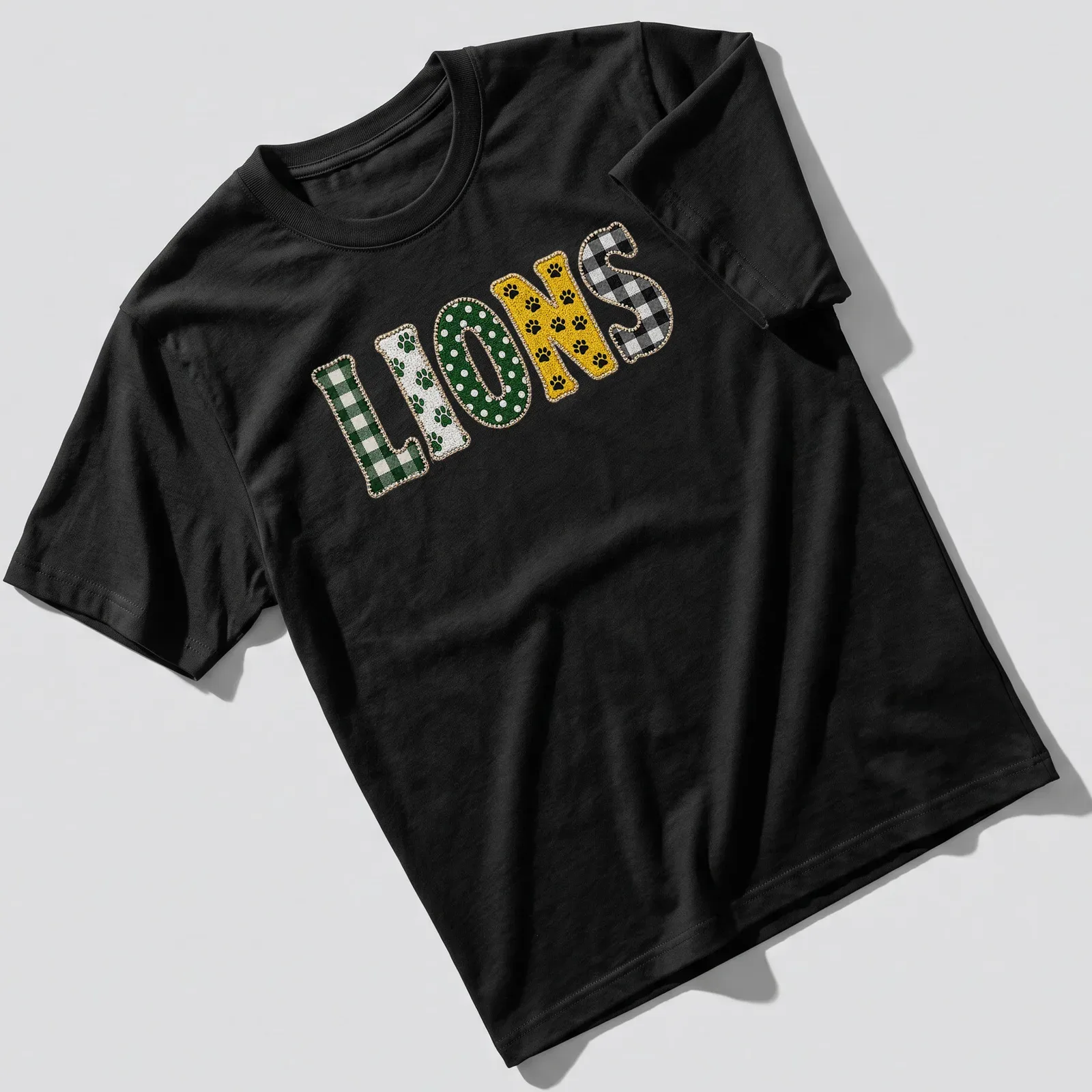 Cute paw pattern featuring playful lions with the word LIONS printed — printed on a unisex t-shirt