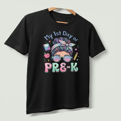 Kawaii cartoon girl with messy bun on a pastel background, celebrating first day of preschool — printed on a unisex t-shirt (angled view)