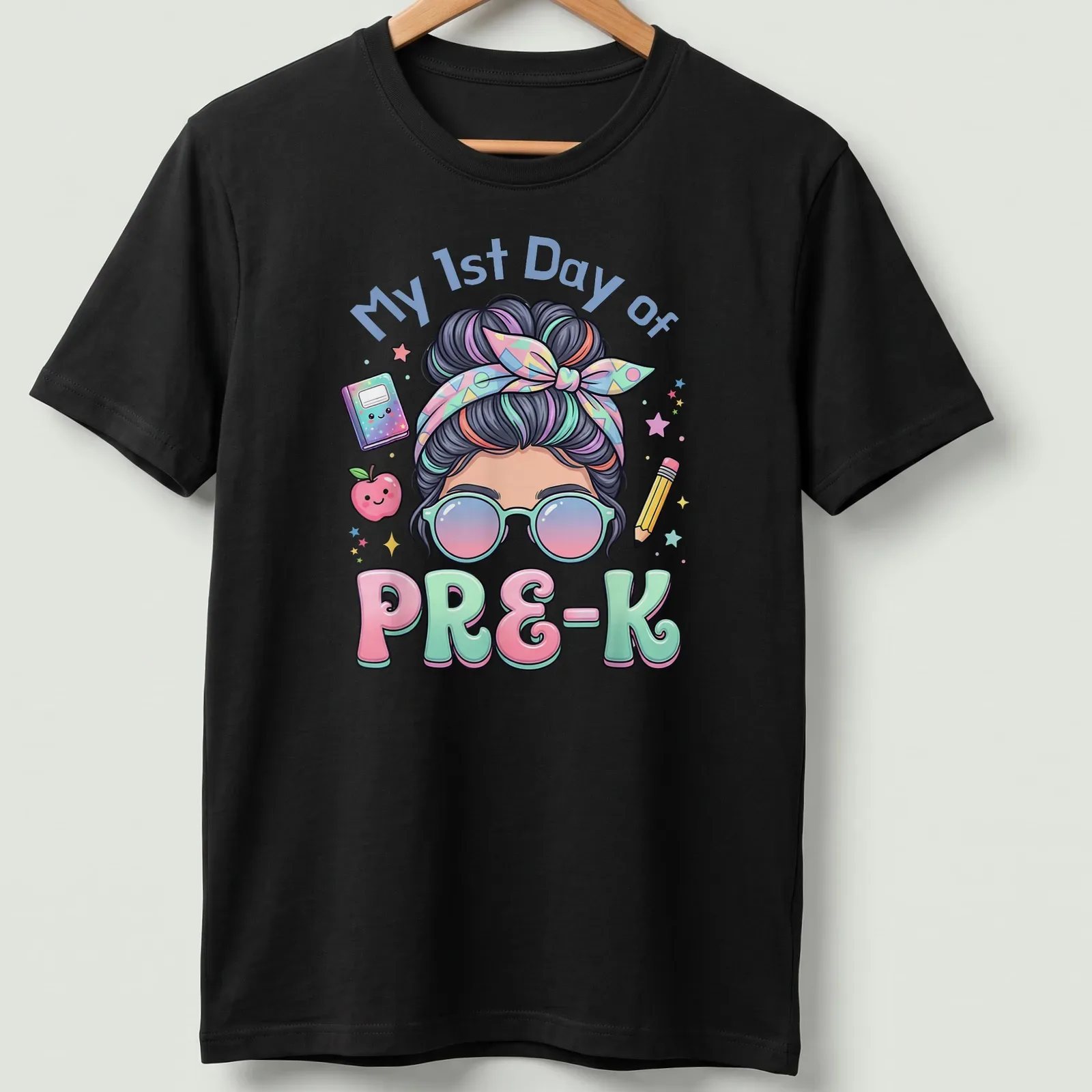 Kawaii cartoon girl with messy bun on a pastel background, celebrating first day of preschool — printed on a unisex t-shirt