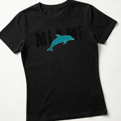 Retro distressed Miami Dolphin t-shirt featuring a dolphin and bold text. — printed on a women's shirt