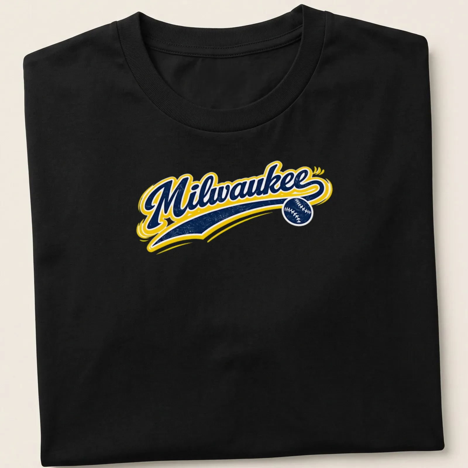 Retro script t-shirt featuring the word Milwaukee with baseball elements in navy, yellow, and white — printed on a unisex t-shirt