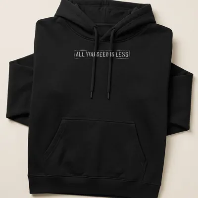 Minimalist design t-shirt with text reading 'All You Need Is Less' in simple typography. — printed on a unisex hoodie