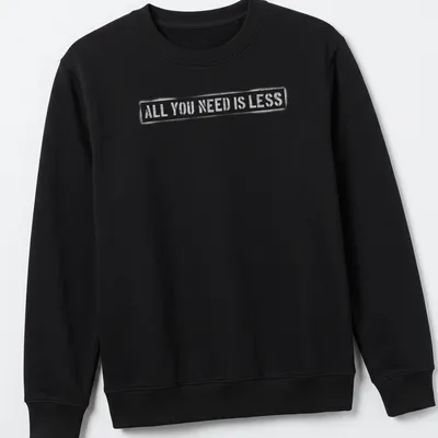 Minimalist design t-shirt with text reading 'All You Need Is Less' in simple typography. — printed on a unisex sweatshirt