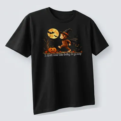 Whimsical illustration of a monkey in a witch hat with playful text — printed on a unisex t-shirt (angled view)