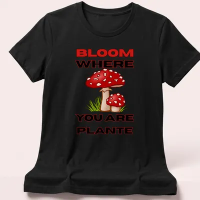Colorful cartoon mushroom design with the text 'BLOOM WHERE YOU ARE PLANTE' in vibrant colors. — printed on a women's shirt